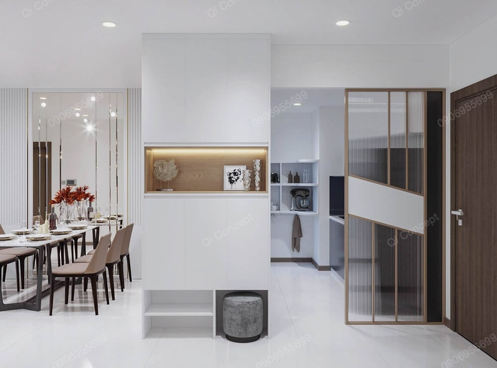 Khu vực bàn ăn và bếp được ngăn cách bằng mảng tường có tích hợp kệ tủ thông minh