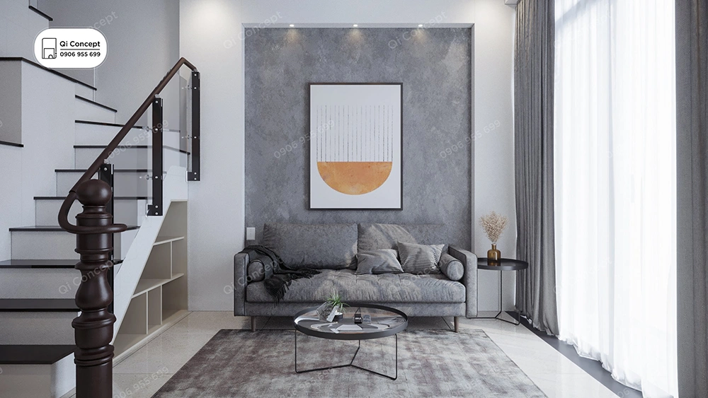 Phòng khách tối giản trong thiết kế nội thất nhà phố với sofa xám, tường hiệu ứng bê tông và cầu thang.