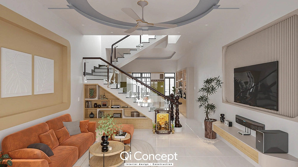 Toàn cảnh phòng khách trong thiết kế nội thất nhà phố với sofa cam và kệ tủ dưới gầm cầu thang.