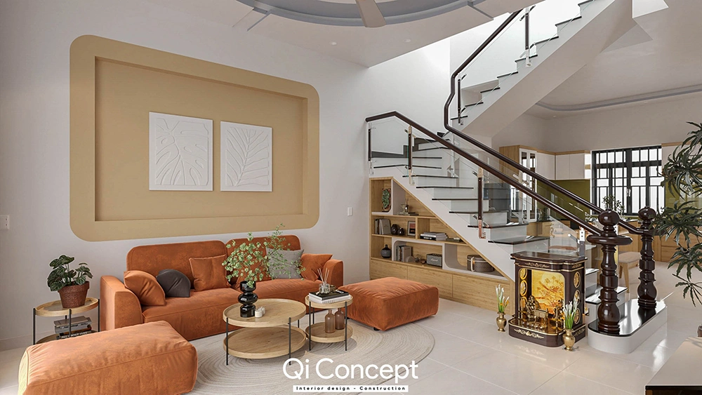 Thiết kế nội thất nhà phố với phòng khách sofa màu cam và bàn thờ ông địa dưới chân cầu thang.