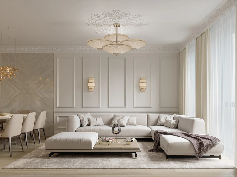 Thiết kế phòng khách tân cổ điển liền bếp cho nhà ống với sofa góc L và tông màu trắng kem nhẹ nhàng.