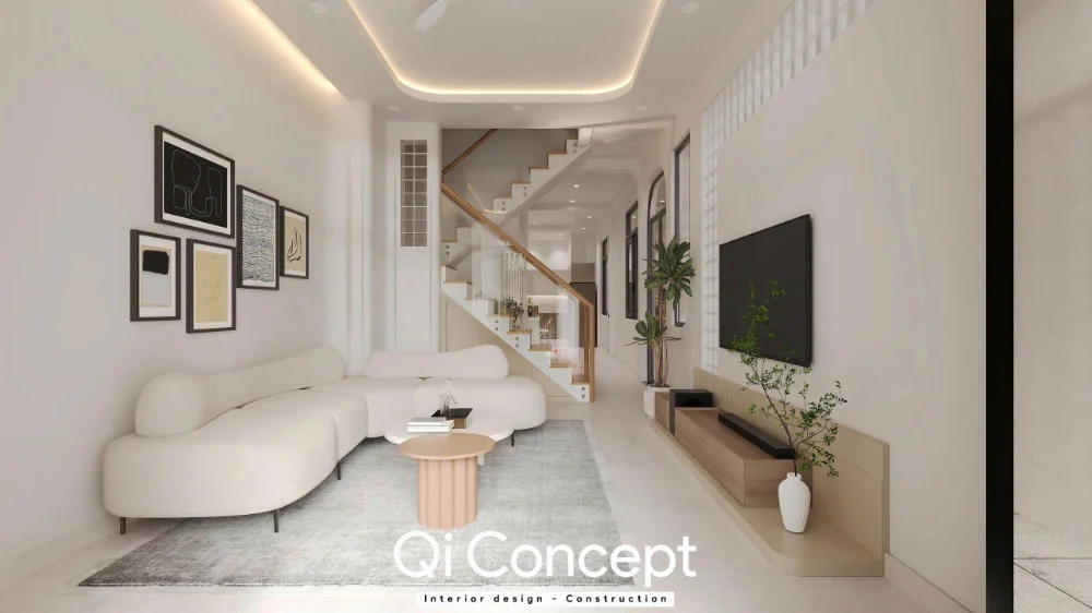Trục nhìn dọc với sofa cong bên trái, kệ TV bên phải và cầu thang phía sau