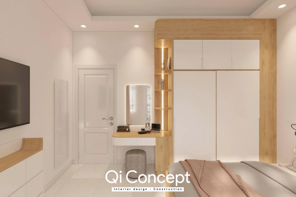 Hệ tủ quần áo lớn kịch trần kết hợp bàn trang điểm có gương đèn LED nền và ghế đôn xám tạo điểm nhấn tinh tế trên nền tường và sàn trắng.